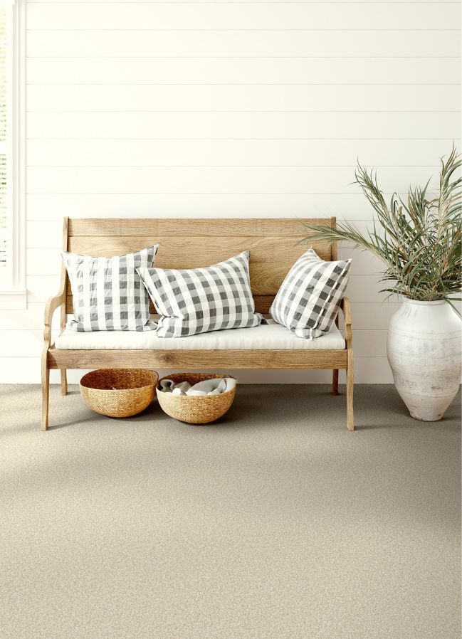 beige carpets in a hallway with bench